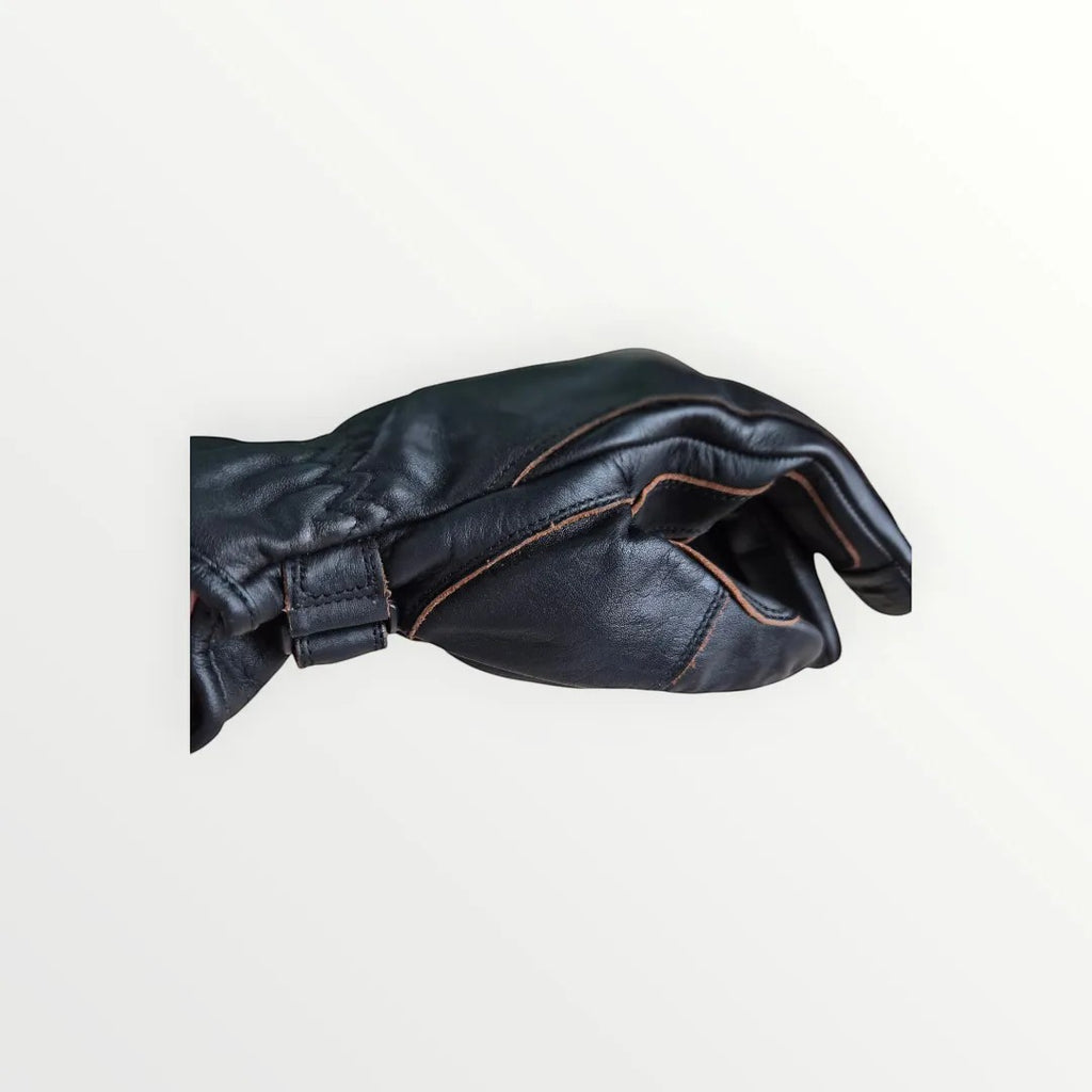 VelvetMoto black leather riding gloves with contrast stitching and adjustable wrist strap.
