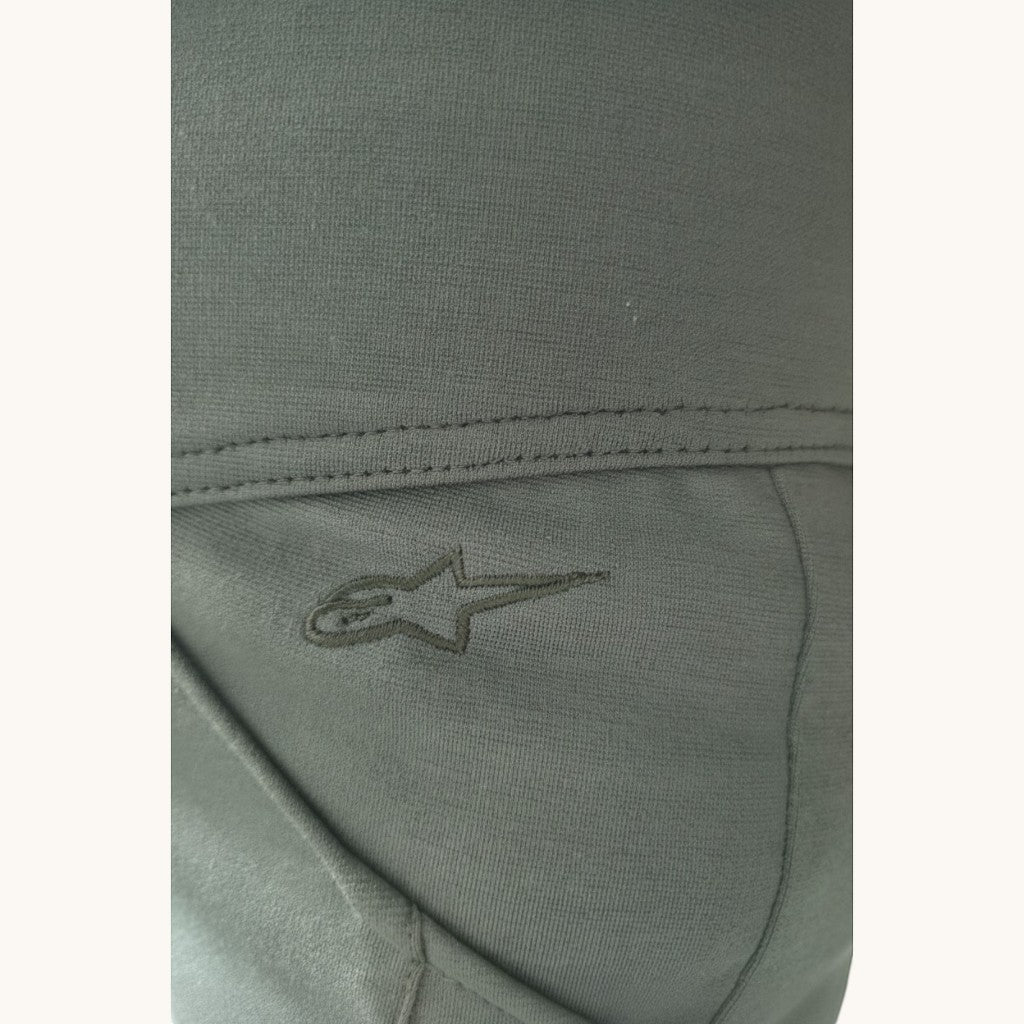 VelvetMoto dark olive green moto leggings with embroidered star logo detail.